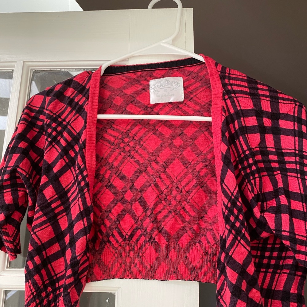 A red and black cropped sweater